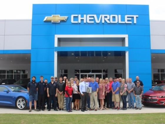 Hug Chevrolet GMC staff in front of building